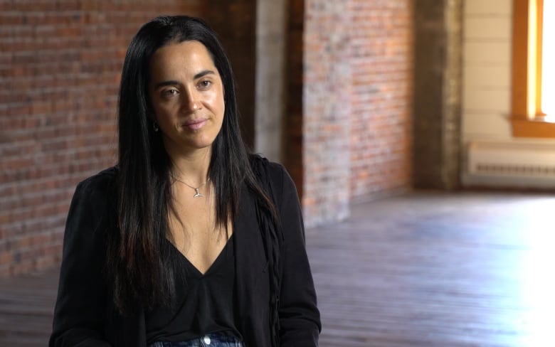 Woman with black hair smiles