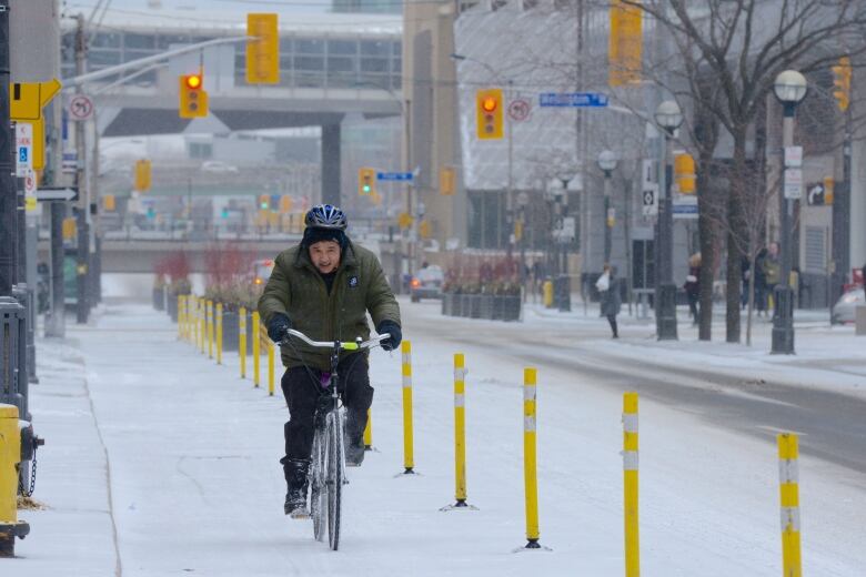 A cyclist on a snowy street.