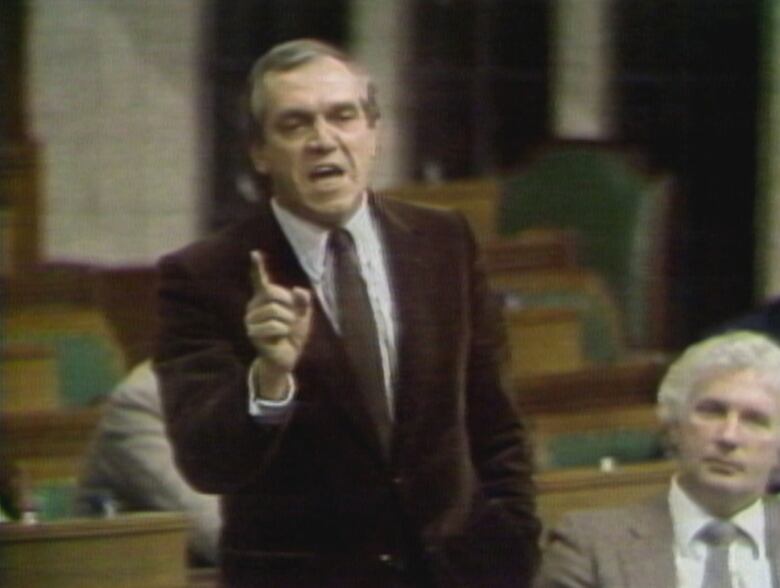 Man raising finger and speaking in the House of Commons