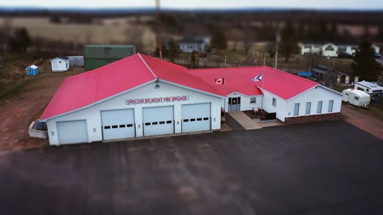 A building with a red roof is shown.