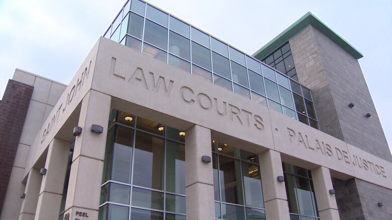 A large grey building with lots of windows and the words 'Law Courts' engraved.