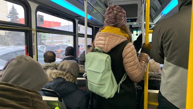 A bus is full of people.