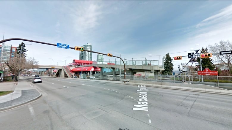 a city street is pictured at an intersection with two sets of traffic lights