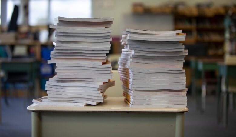 Textbooks stacked on a desk.