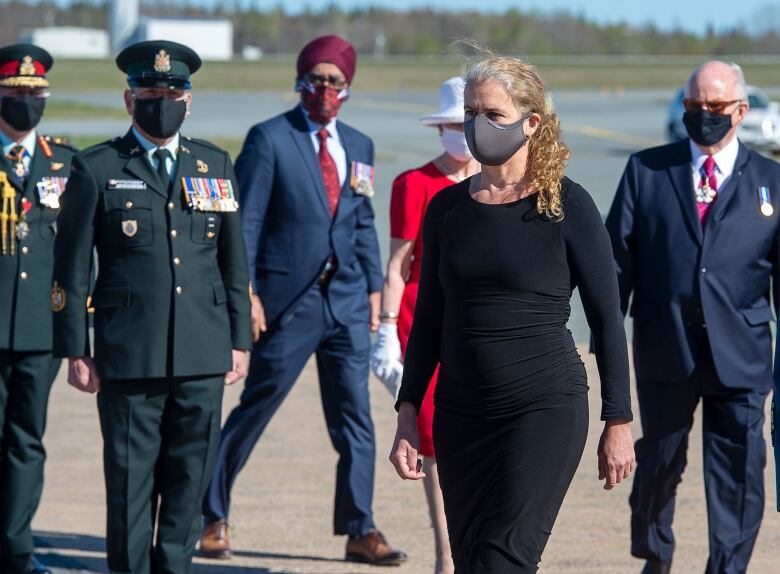 Governor General Julie Payette, followed by Defence Minister Harjit Sajjan, attends the homecoming ceremony for RCAF Capt. Jennifer Casey at Halifax Stanfield International Airport in Enfield, N.S. on Sunday, May 24, 2020. Casey, a military public affairs officer and a Halifax native, was killed in the crash of a Snowbirds Tutor jet in a residential area of Kamloops, B.C.