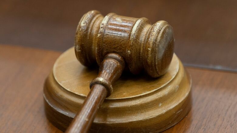 A judge's gavel on a desk.