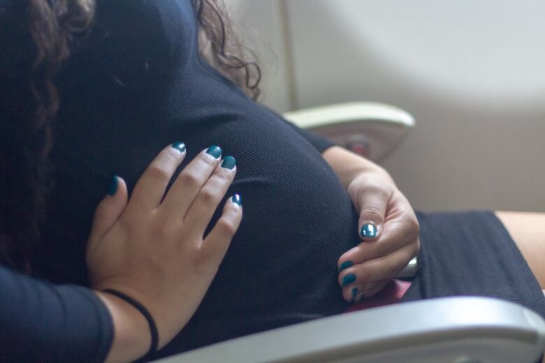 A pregnant woman on an airplane.