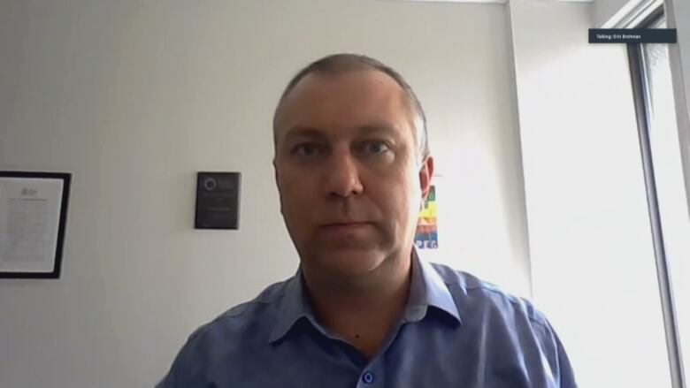 A man looks serious in a screengrab of a virtual interview.