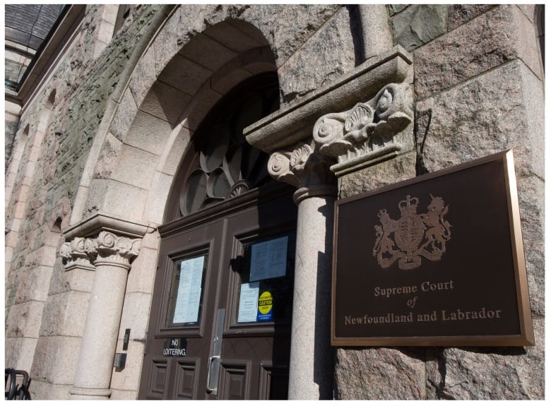 A photo of an old stone building with a sign that reads Supreme Court of Newfoundland and Labrador. 