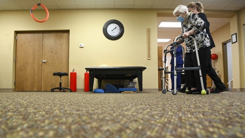 A photo of a resident and worker inside a long-term care home.