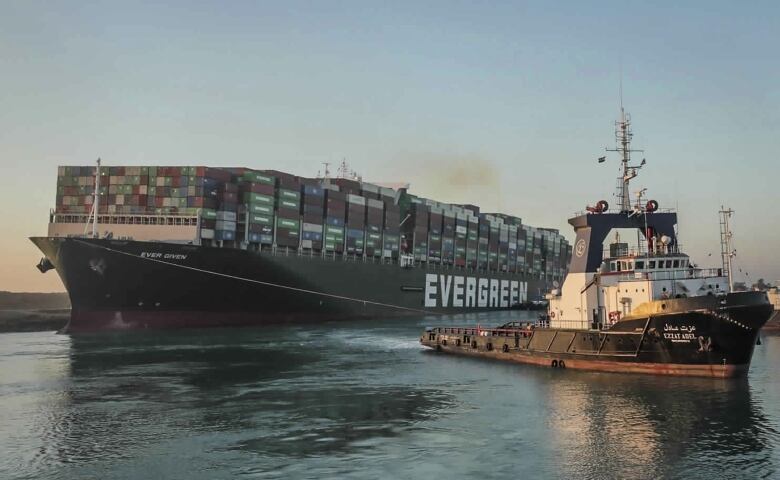 The Ever Given, a Panama-flagged cargo ship is pulled by one of the Suez Canal tugboats, after it got stuck in the Suez Canal