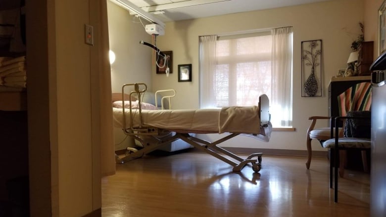 A nursing home bed, as seen from the doorway.