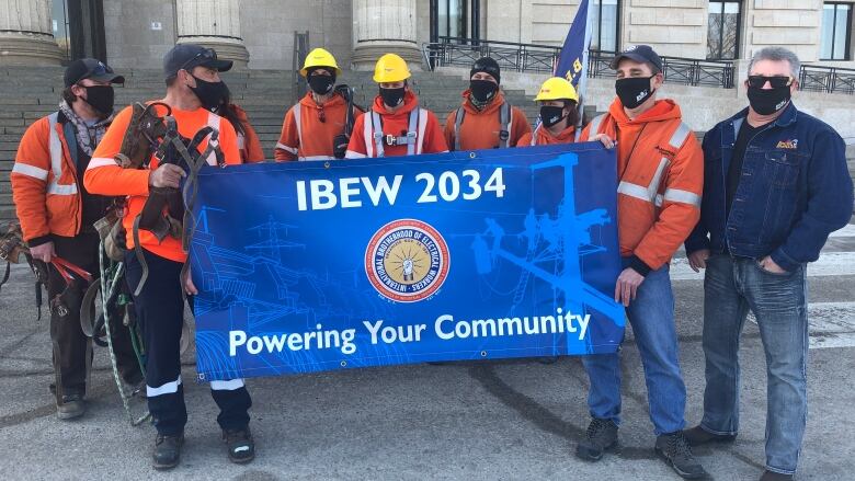 Men in Hydro work equipment hold a banner, representing their logo.