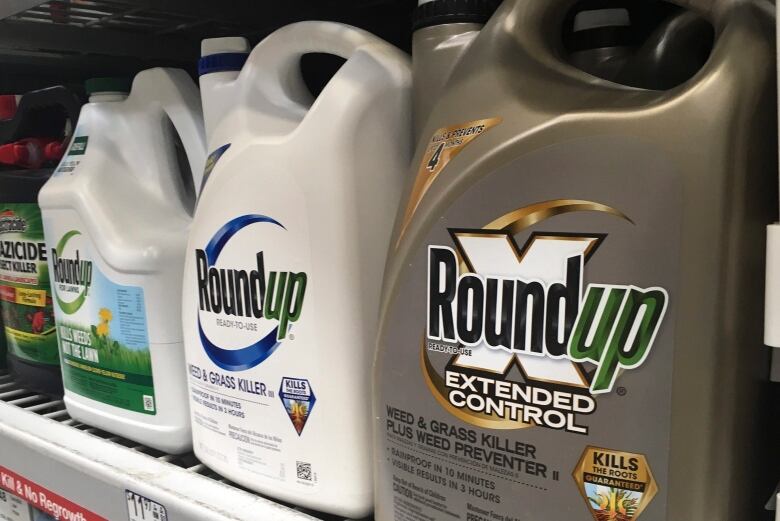 Bottles of Roundup on a shelf.