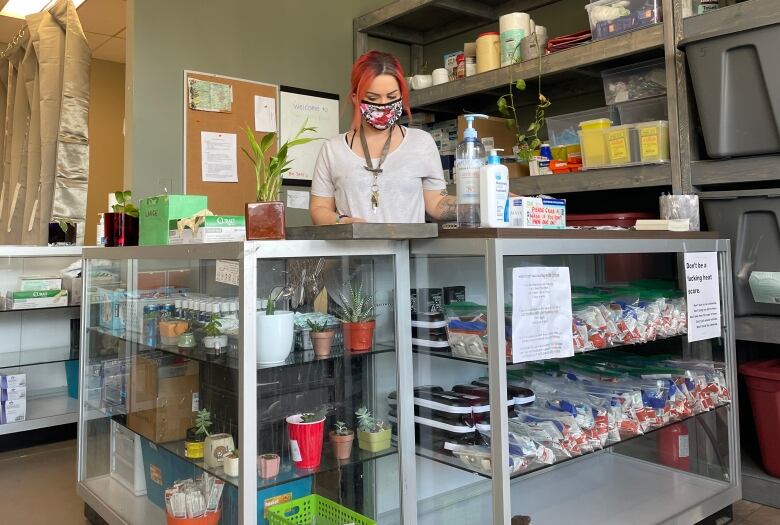 A person stands at the counter inside the Pounds Project in Prince George, B.C. 