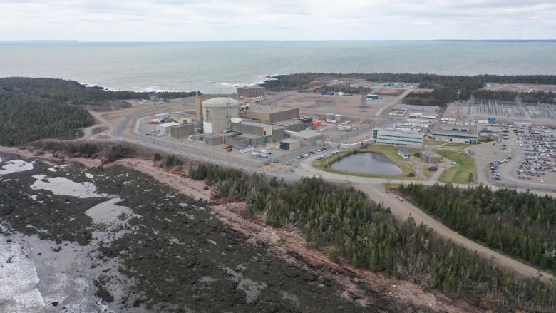 A picture taken from the air of a nuclear power plant on the edge of the land next to the Bay of Fundy.