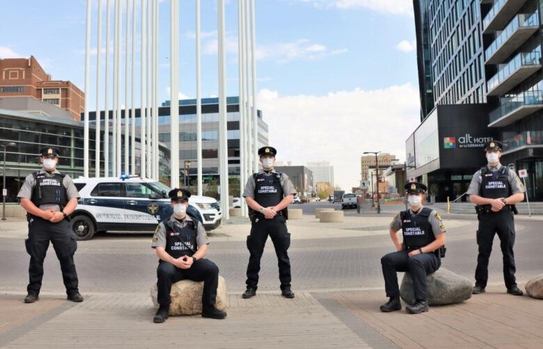 Multiple alternative response officers pose for a photo in downtown saskatoon