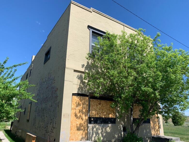 a boarded up building is pictured