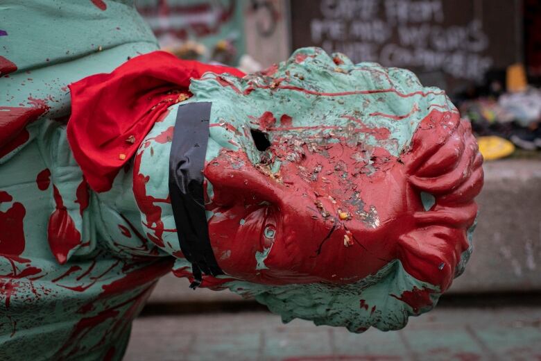 A statue of Egerton Ryerson lies on the grounds of the university in Toronto that bears his name, after being toppled on June 6. 