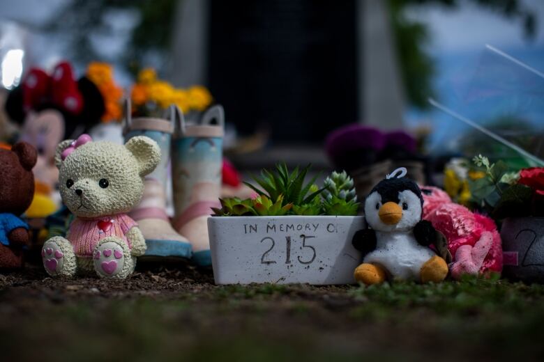 Shoes and stuffed animals are photographed on the grounds of the former Kamloops Indian Residential School.