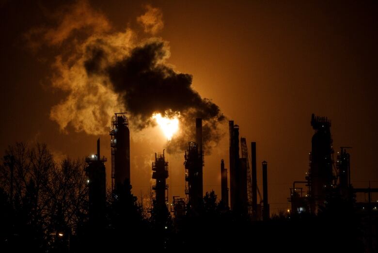 A flare stack lights the sky from the Imperial Oil refinery in Edmonton Alta, on Friday December 28, 2018. Alberta's oilsands are at the centre of a closely watched court battle in New York today. The state's attorney general is accusing Exxon, which has extensive oilsands interests through its subsidiary Imperial Oil, of deliberately misrepresenting the risks those operations face as governments move to fight climate change. THE CANADIAN PRESS/Jason Franson