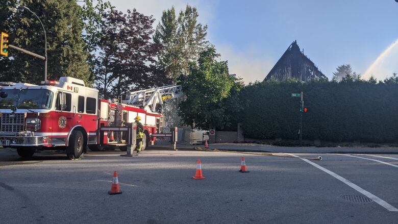 A fire truck is seen with a church in the background.