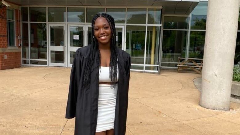 A Black woman wearing a graduation gown