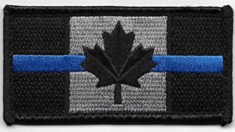 A monochromatic Canadian flag is bisected by a thin blue line.