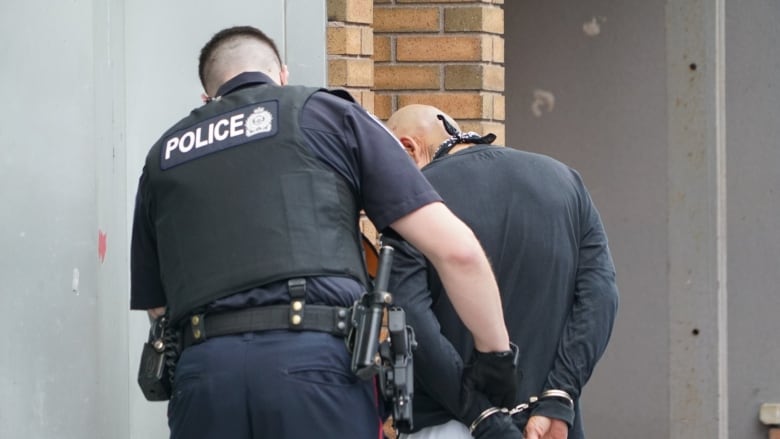 A London police officer makes an arrest in the city's core. 