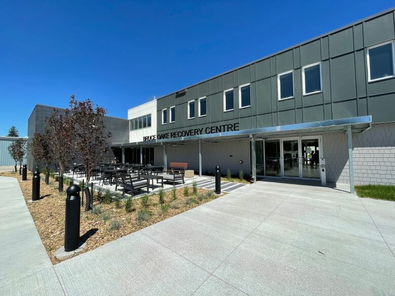 The front of a large building with a small courtyard in the front.