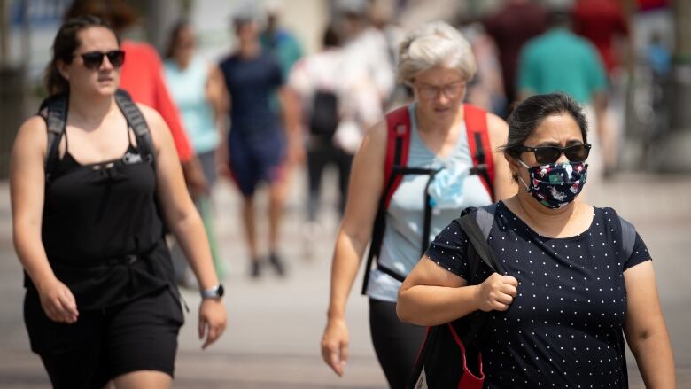 People walk in downtown Ottawa on Aug. 9, 2021, during the COVID-19 pandemic.