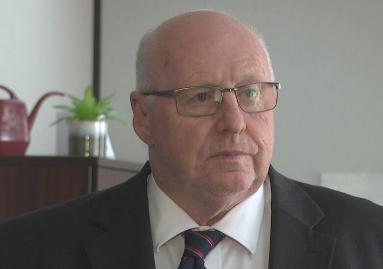 Man in glasses and business suit. 