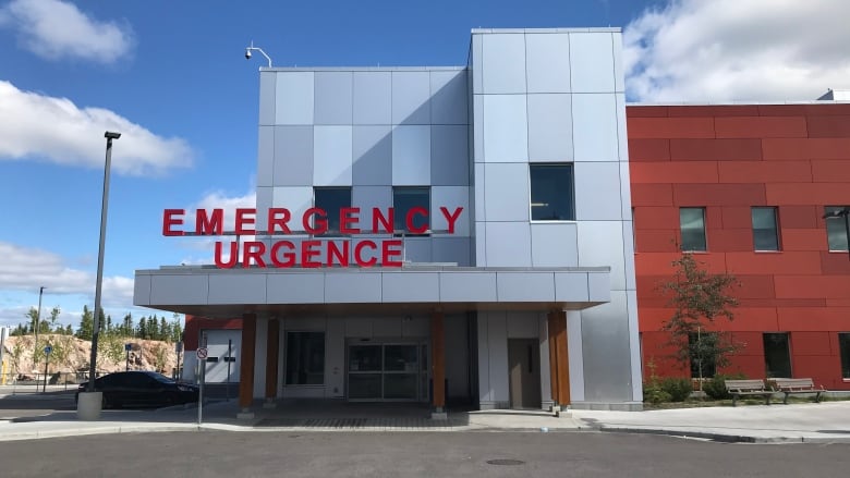 Building with sign that says Emergency Entrance