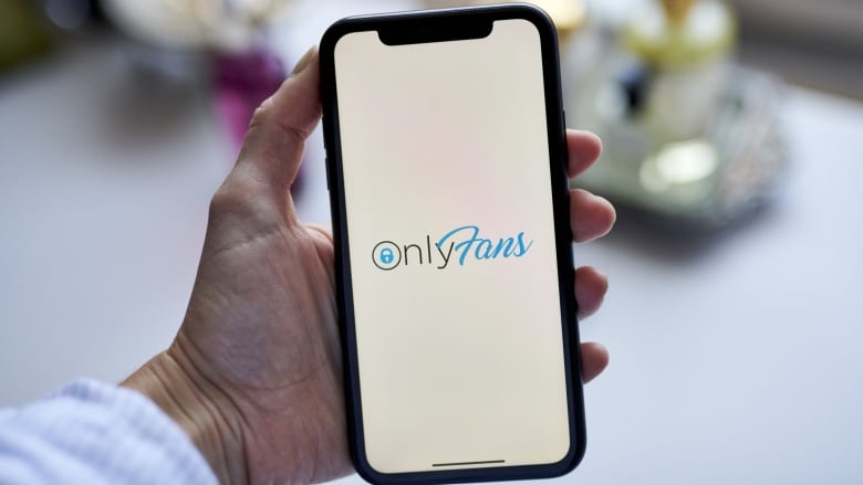 The OnlyFans logo on a smartphone.