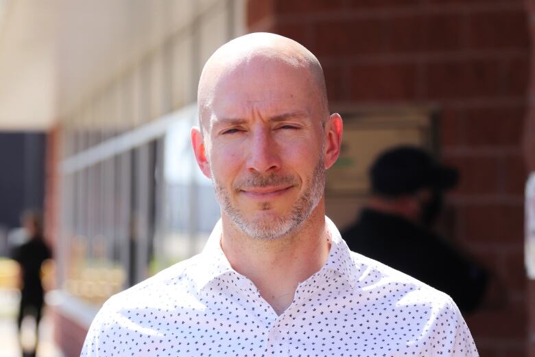 A man poses for a portrait.