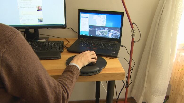 A person working on a computer at a desk.