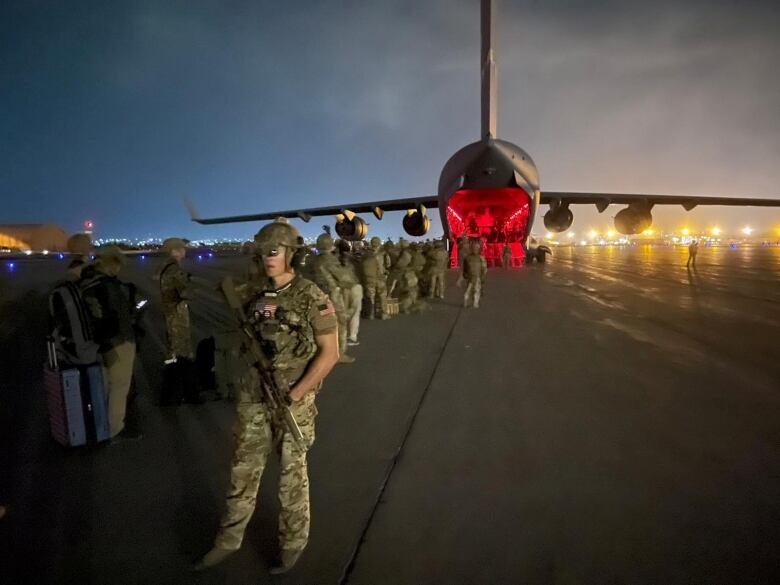 Military stand with a large military plane in the background.