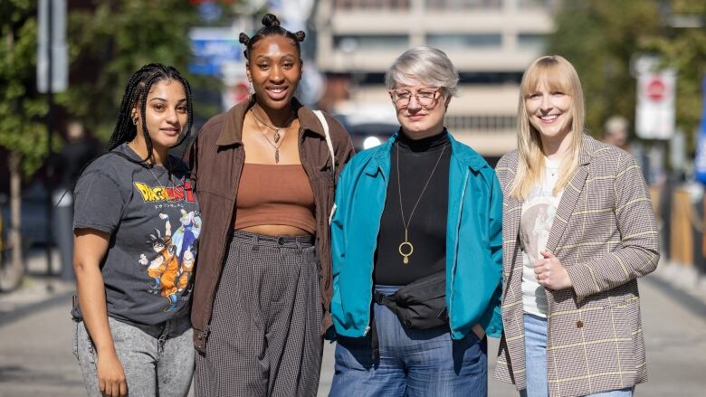 Four women standing on a street