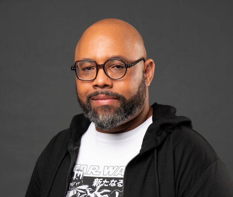 A headshot of a man in a portrait studio.