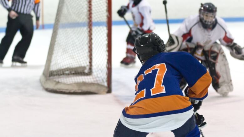 Hockey players on an ice rink. 