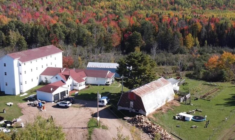 Aerial shot of farm with white buildings