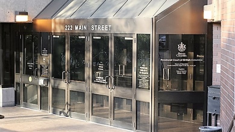 An exterior photo of a building lobby with glass doors.