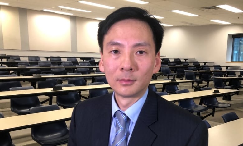 Man in suit in classroom.