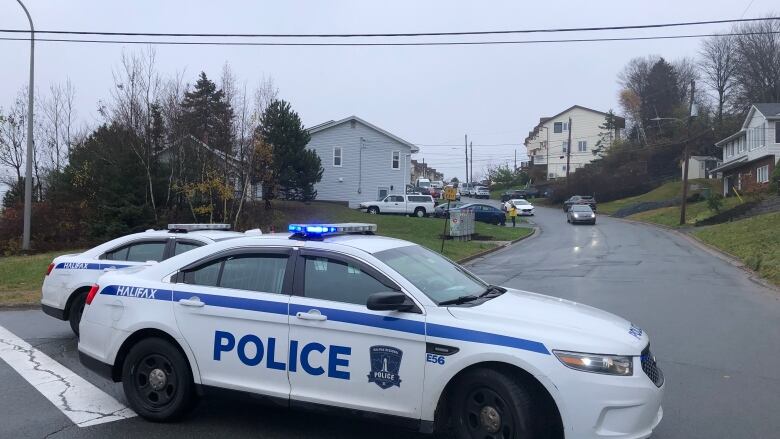 A police car blocks a road.