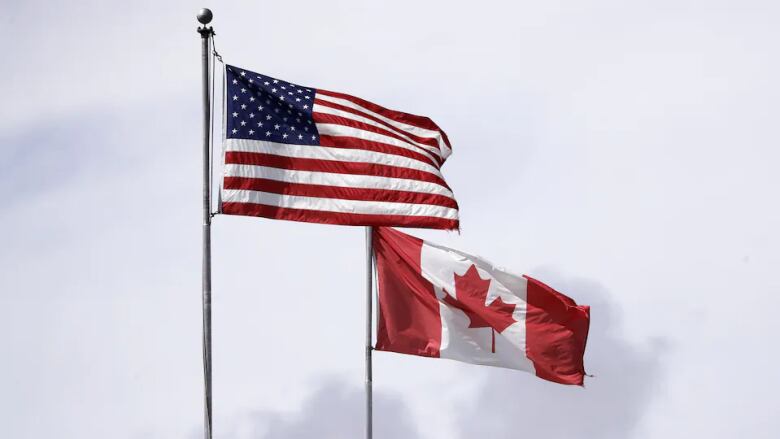 Canadian and U.S. flags are pictured on poles.