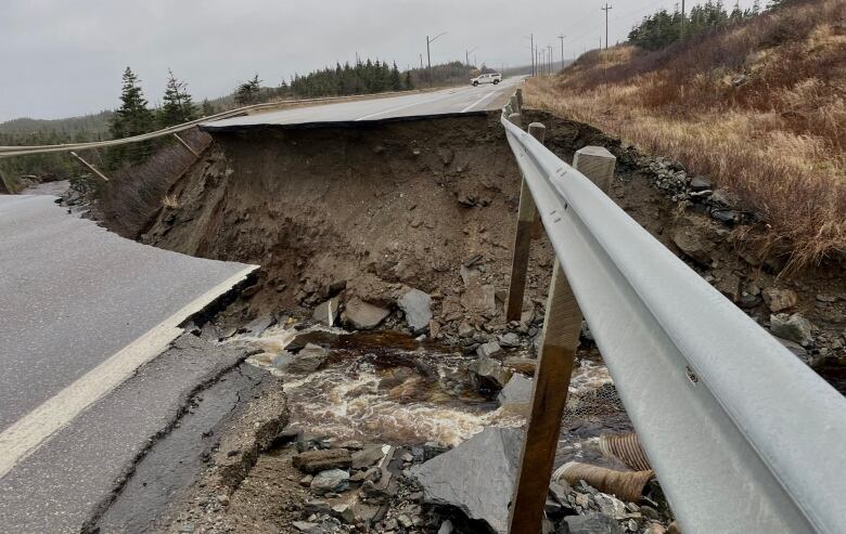 A washed out highway and guardrail.