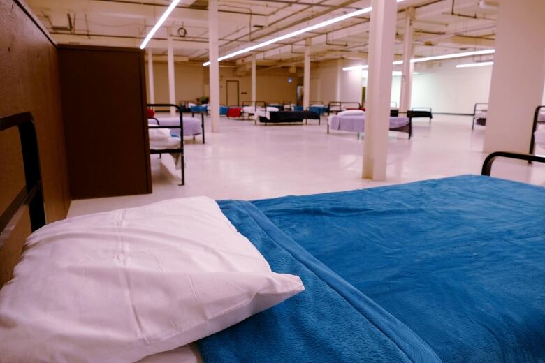 N'Dinawemak - Our Relatives' Place, rows of cots for sleeping in a large room.