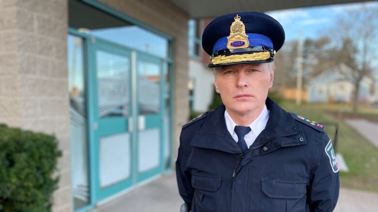 man in police uniform in front of building