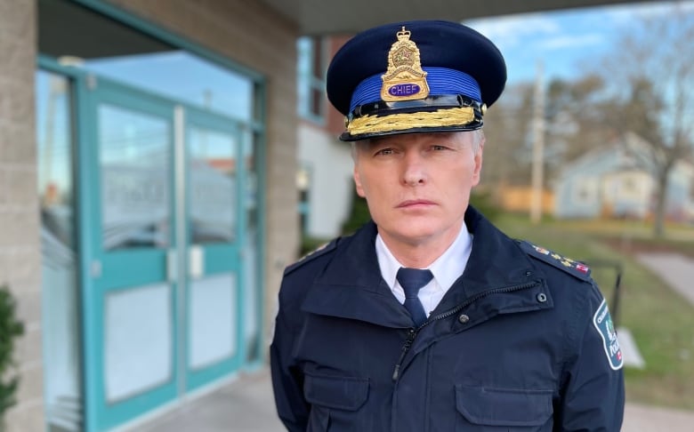 man in police uniform in front of building