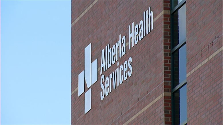 An Alberta Health Services sign on a brick building.